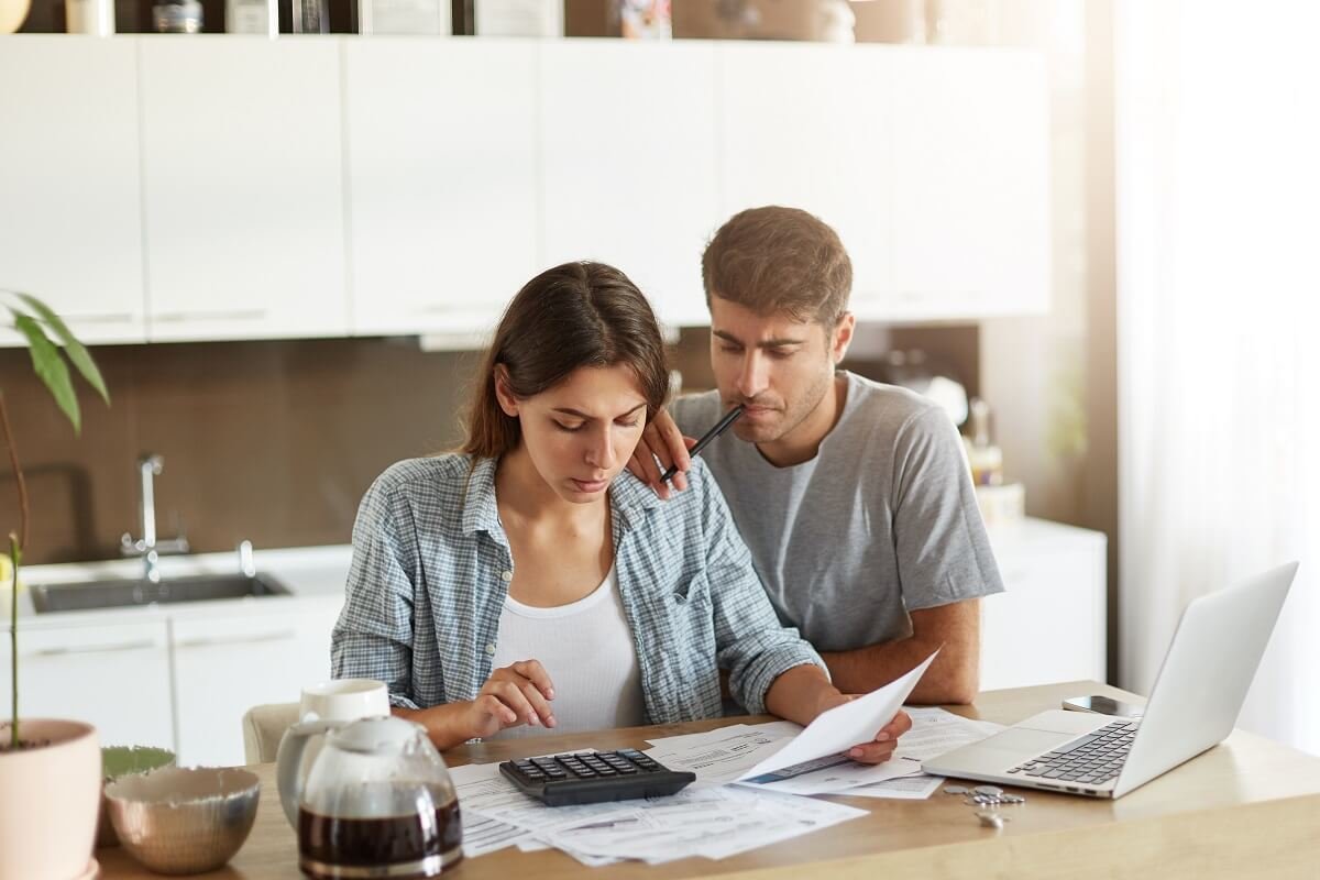 couple looking over investment details at kitchen table