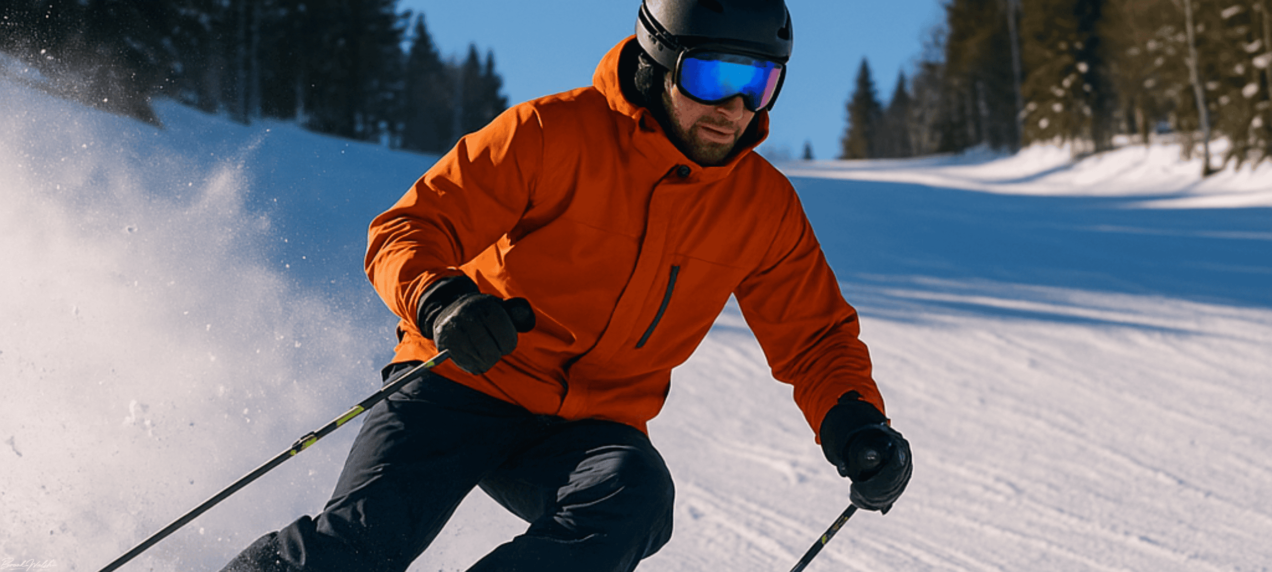 Skier carving fresh powder on a groomed slope at a Michigan ski resort under a clear blue winter sky.