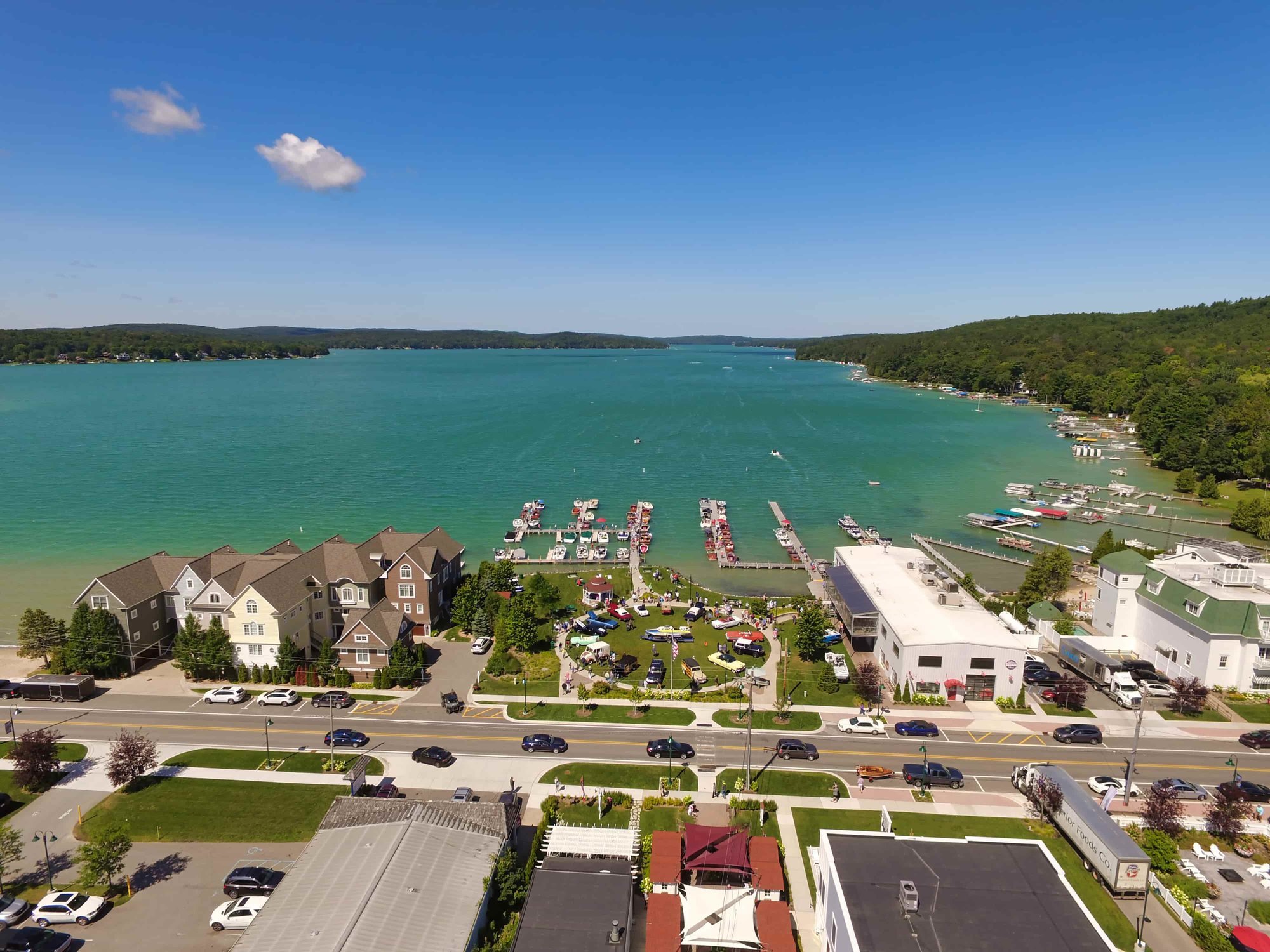 Aerial view contrasting the serene Walloon Lake with the vibrant Torch Lake.