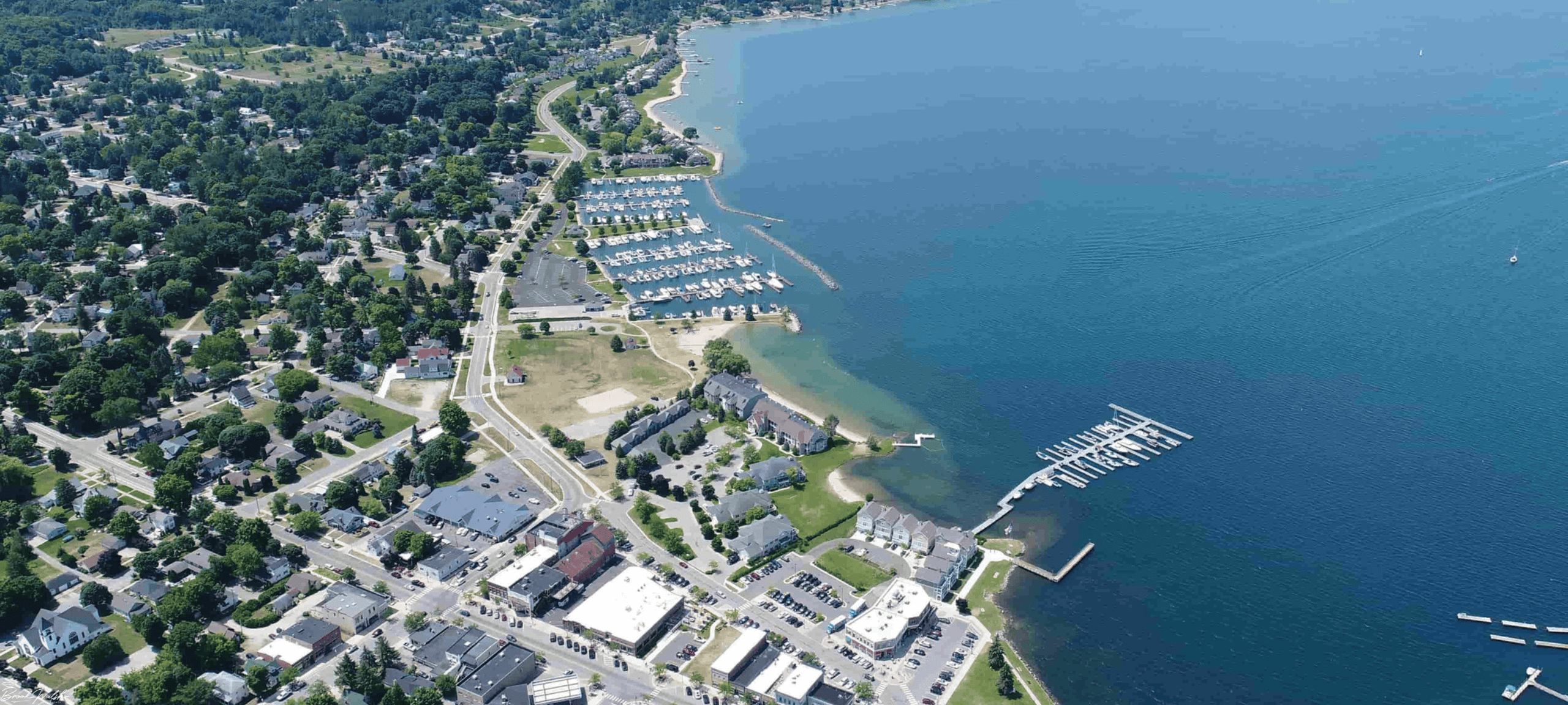 Downtown Boyne City waterfront with boats, shops, and people enjoying the vibrant town atmosphere