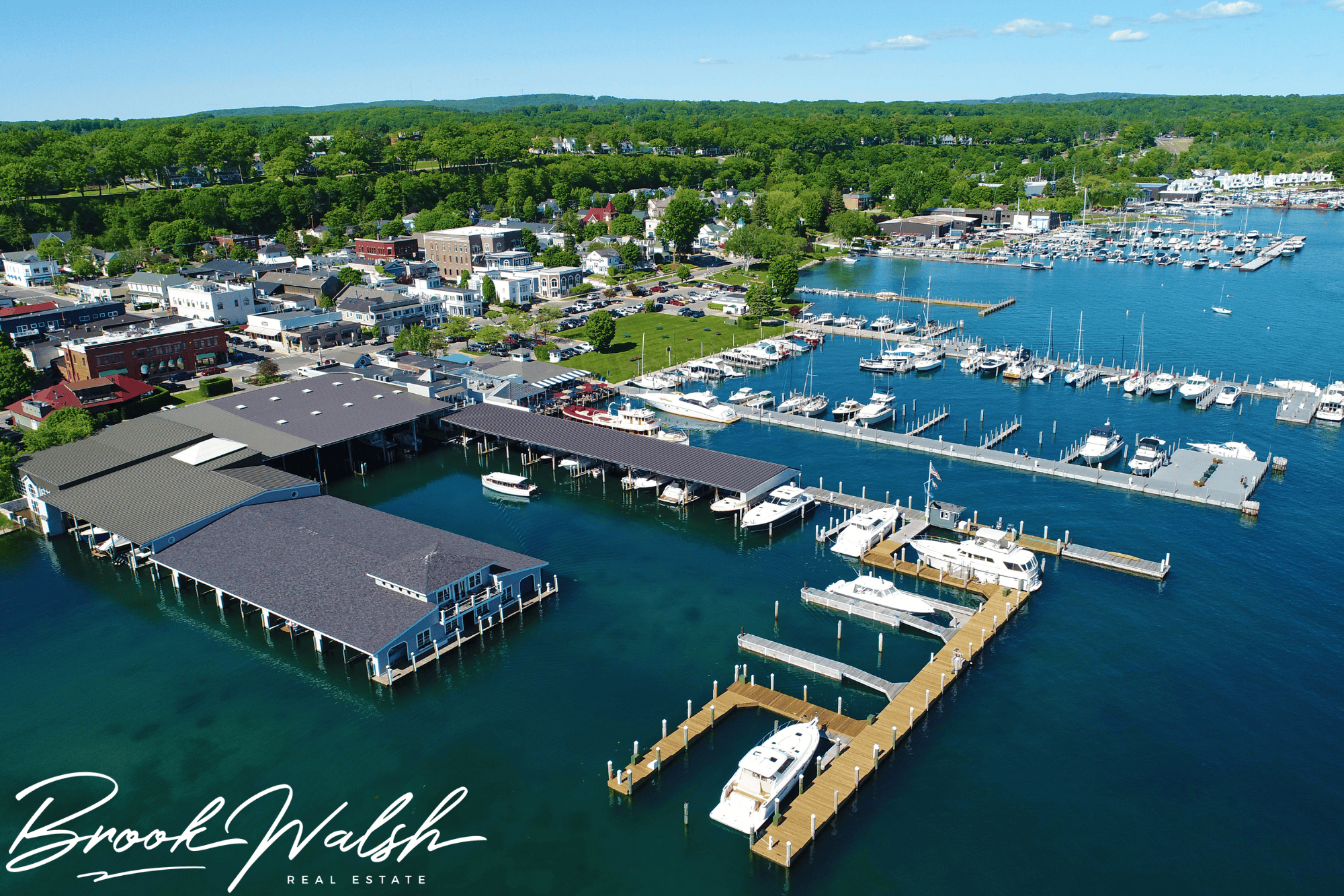 Boats docked at Harbor Springs Michigan Marina with scenic lake views and blue skies