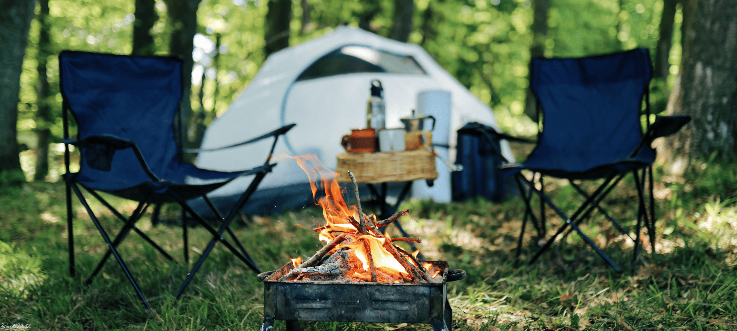 Tents and RVs set up at a scenic Lake Charlevoix campsite