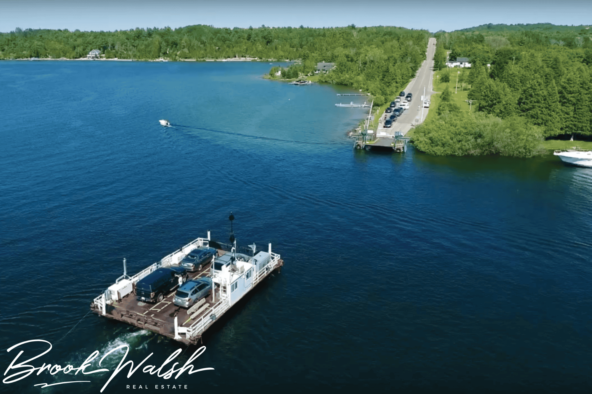 Scenic view of Lake Charlevoix Car Ferry crossing with vehicles onboard during sunset