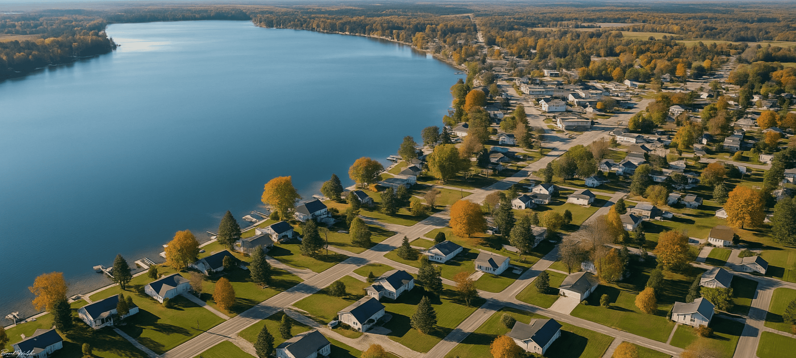 Aerial view of Lake City, MI showing homes for sale along Missaukee Lake shoreline