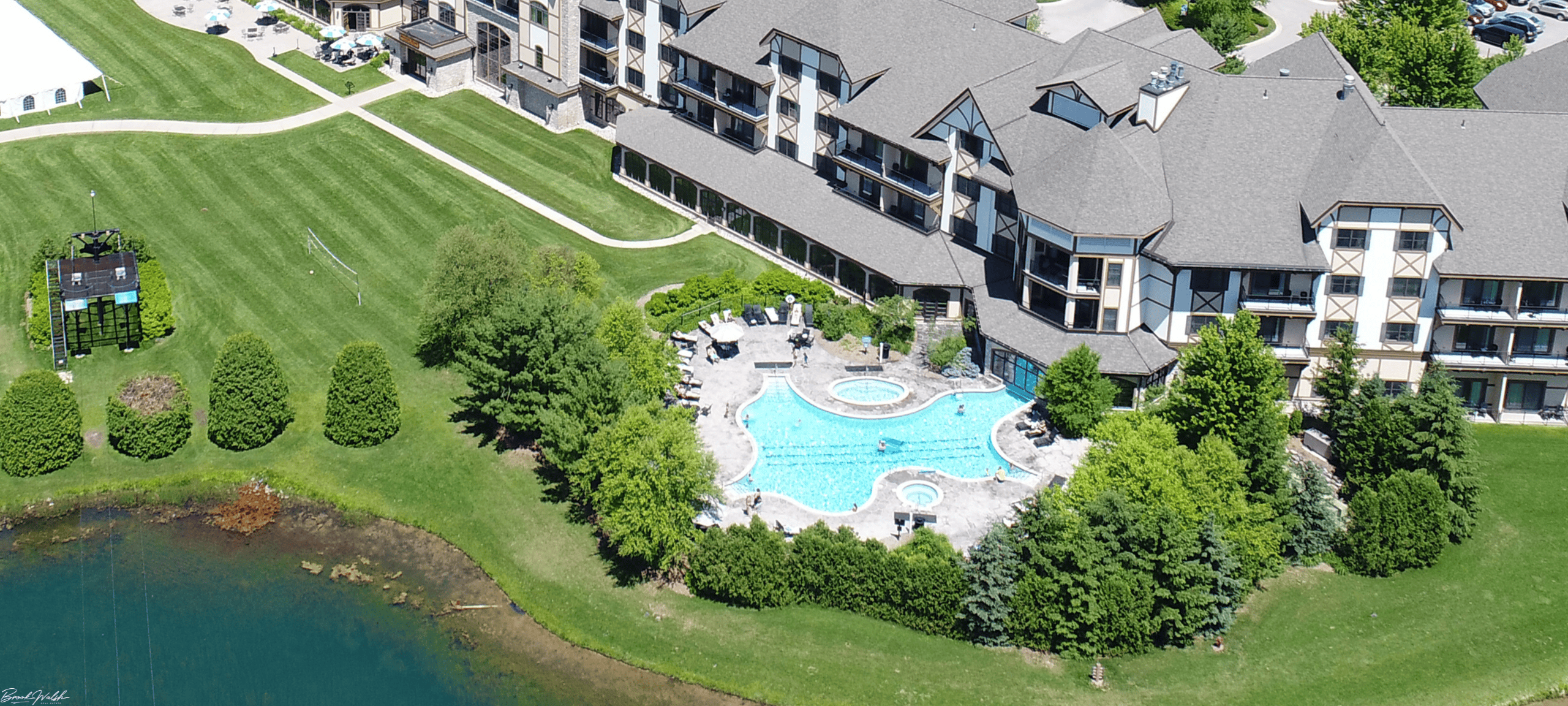 Mountain Grand Lodge at Boyne Mountain Resort nestled among snow-topped pines with ski slopes in the background