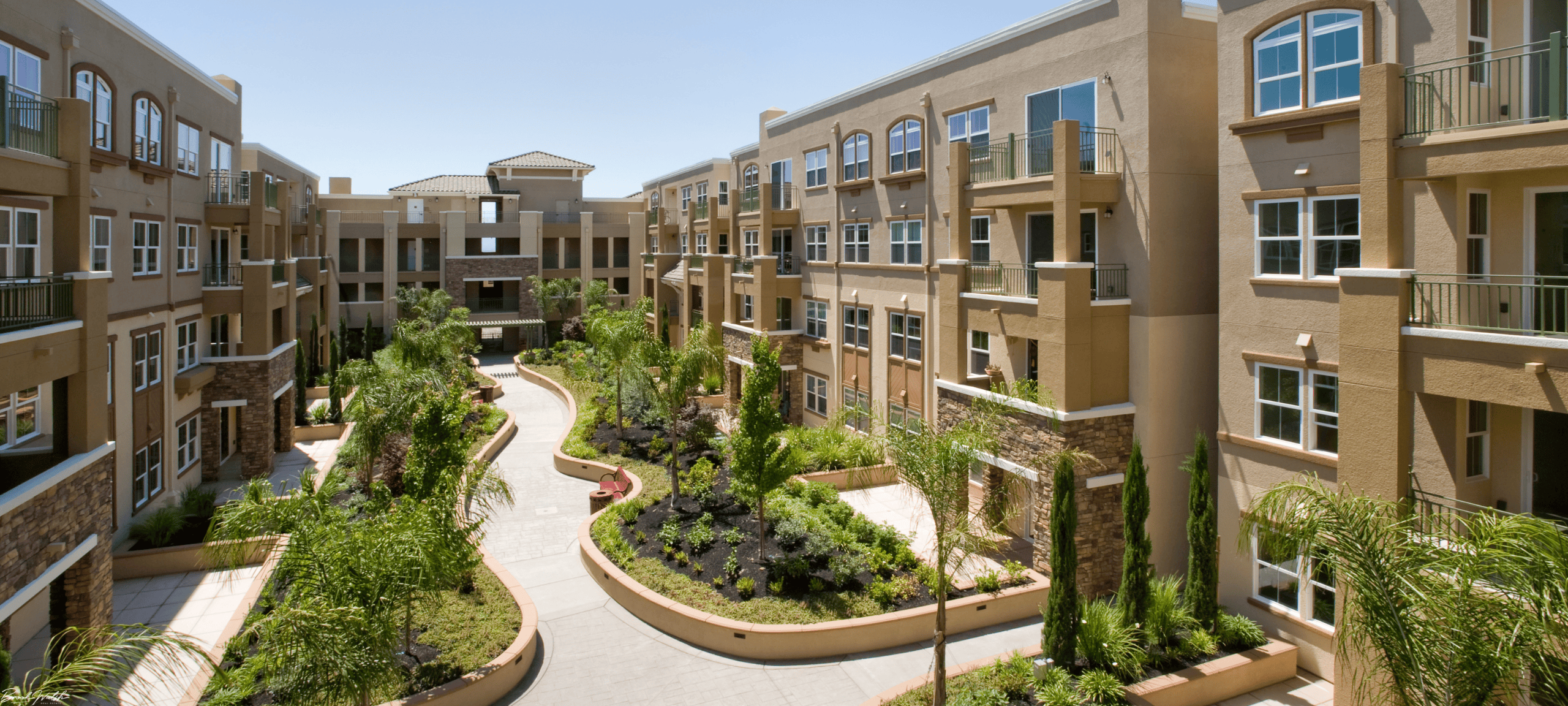 Exterior view of Hamlet Village Condominiums with landscaped paths