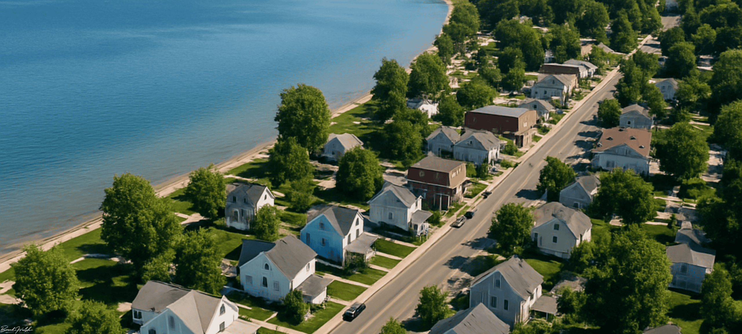 Aerial view of downtown Suttons Bay, MI homes by the bay