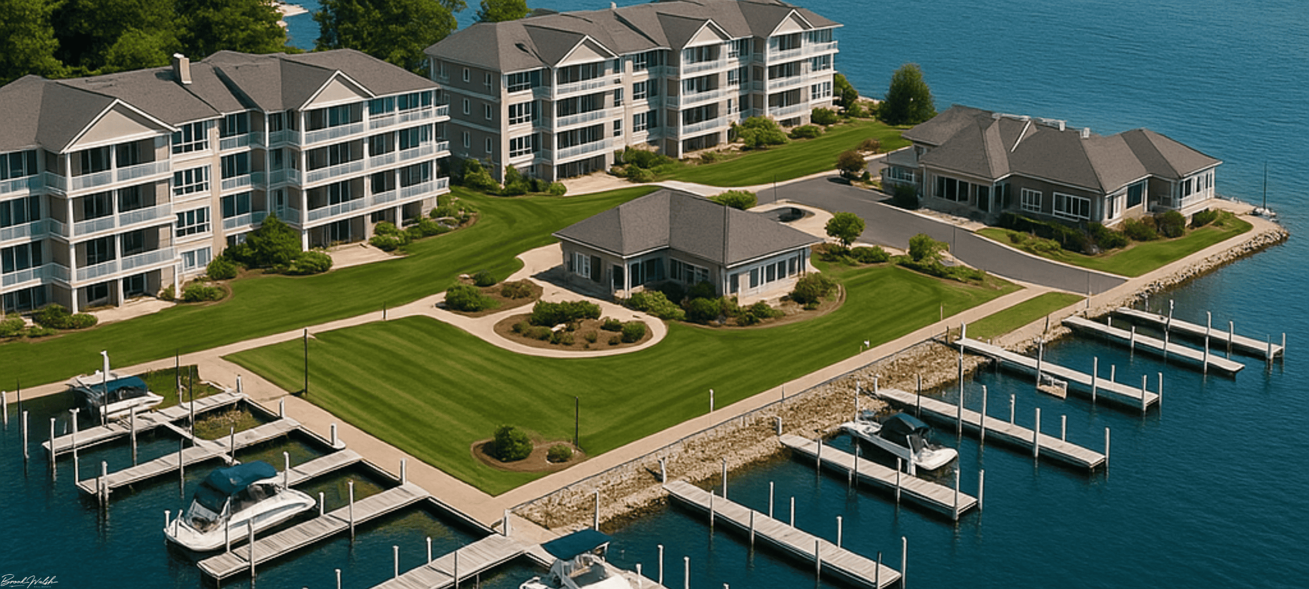 Aerial view of The Landings Condos on Lake Charlevoix featuring private docks and modern lakeside amenities